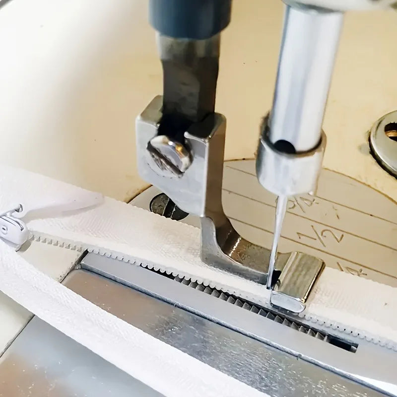 Close-up of an industrial steel presser foot with an invisible zipper on a sewing machine.