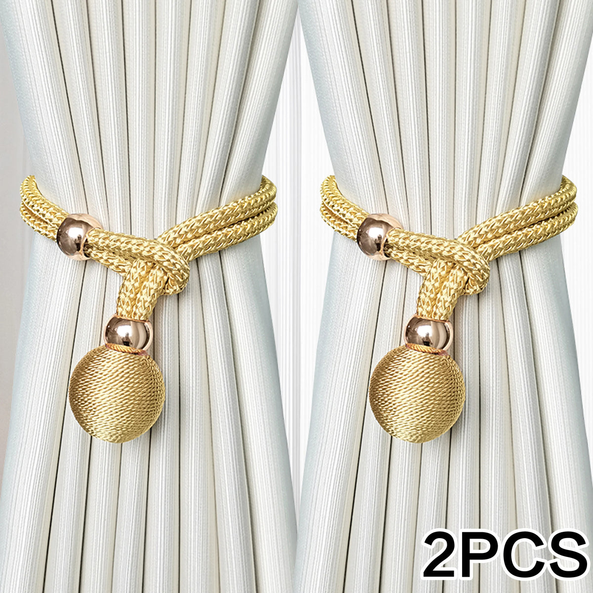 Two sets of gold-colored fabric tiebacks with knotted cords and spherical tassels against a light background