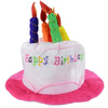 A colorful birthday candle hat with striped decorations on a pink felt base.