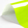 A sheet of bright lime green heat transfer vinyl being peeled off a white backing.