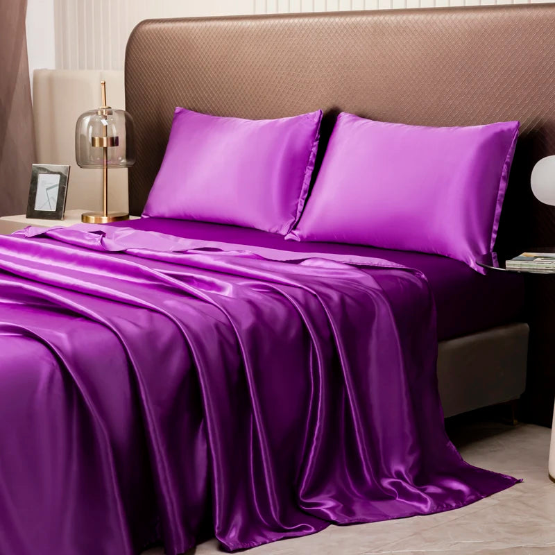 A luxury solid satin bedding set featuring vibrant purple sheets and pillows on a bed.
