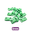 A pile of green adjustable plastic paracord buckle bracelets.