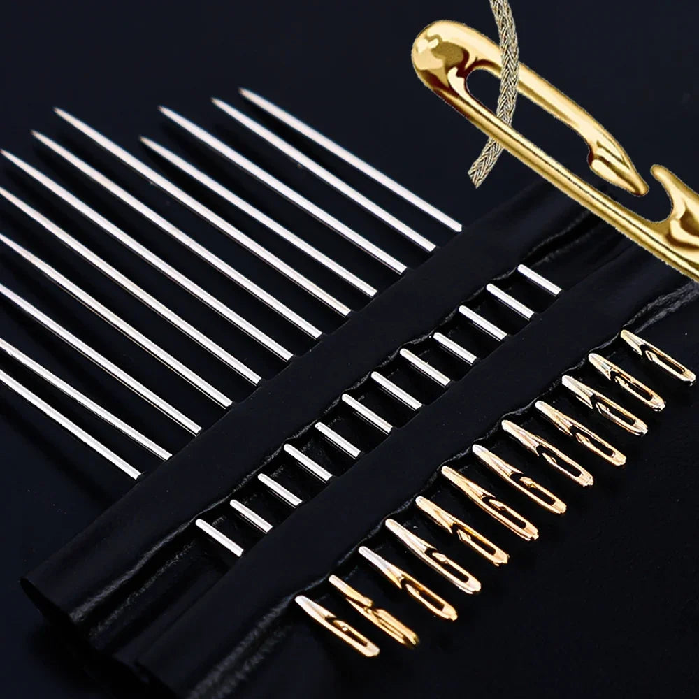 A close-up of a black sewing kit with various size stainless steel needles and a gold-colored tool.