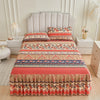 Floral ruffle bed skirt set featuring a multi-colored patterned bedspread and upholstered headboard.