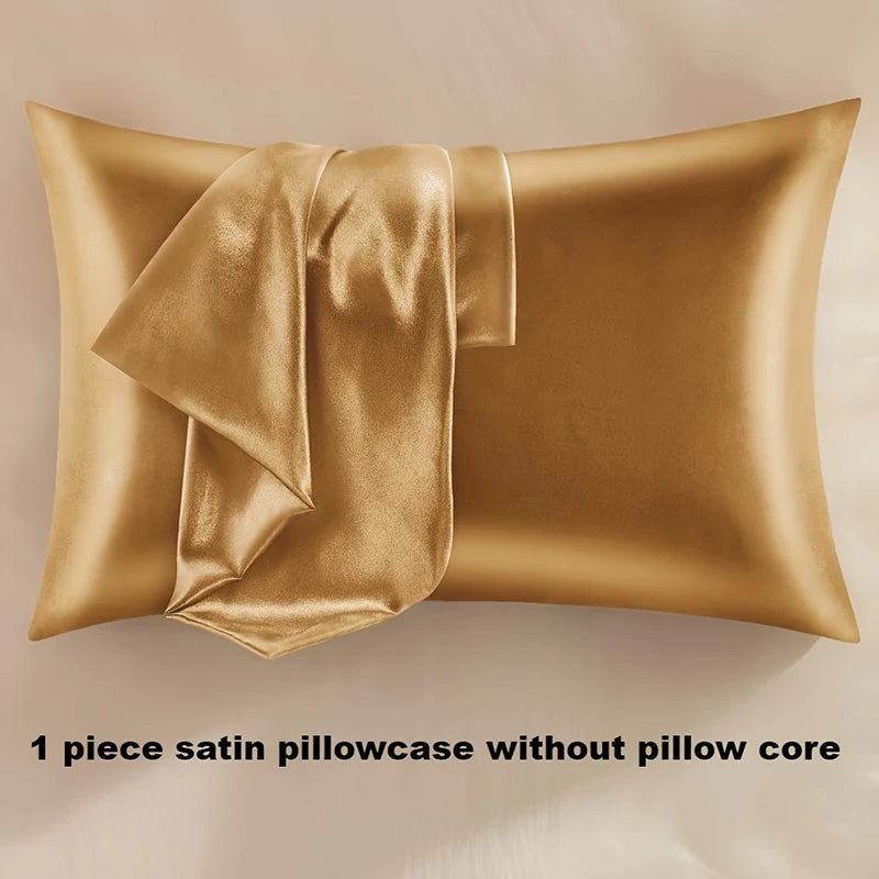 A golden satin pillowcase with an envelope closure draped over a pillow.