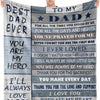 A gray knit blanket featuring text dedicated to a father, including messages of love and gratitude from his daughter.