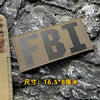 A dark olive tactical hook and loop patch with the letters FBI is displayed on a rough stone background.