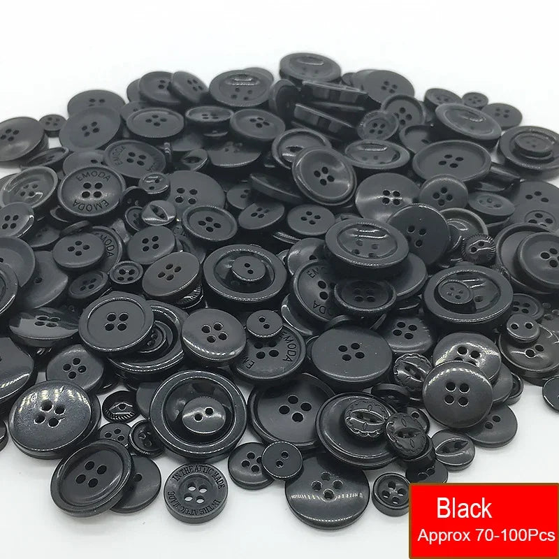 A pile of assorted black resin sewing buttons for crafting and DIY projects