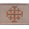 A rectangular embroidered patch in tan fabric featuring a brown cross design.