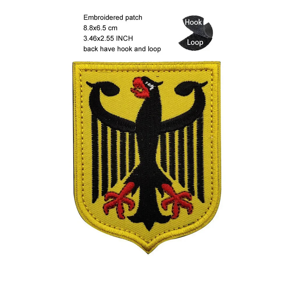 Yellow embroidered patch featuring a black eagle shield design with red accents and hook and loop backing.