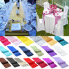 A collection of satin table runners in various colors including pink, yellow, blue, green, purple, and red.