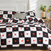 Black and white checkered duvet cover set with heart patterns and pillows on a bed.