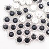 Silver and black crystal rhinestone sew-on buttons arranged in a floral pattern