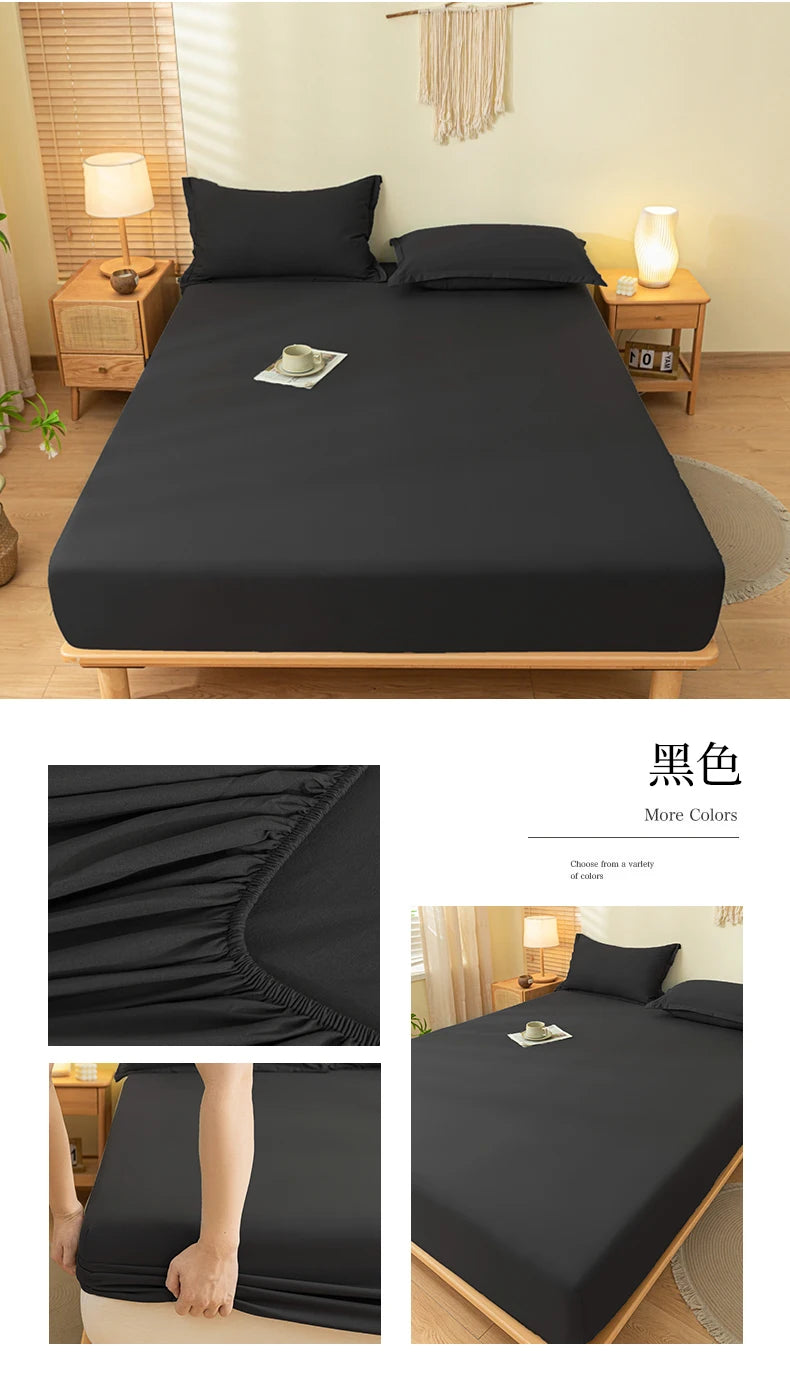 A black fitted bed sheet set displayed on a wooden bed frame with matching pillows and bedding.