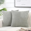 Gray corduroy patchwork pillow covers with vertical ribbed texture on a white sofa
