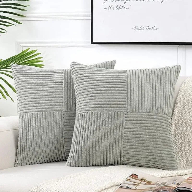 Gray corduroy patchwork pillow covers with vertical ribbed texture on a white sofa