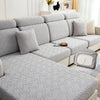 A gray jacquard plush sofa cushion cover featuring a geometric woven pattern on a sectional sofa.