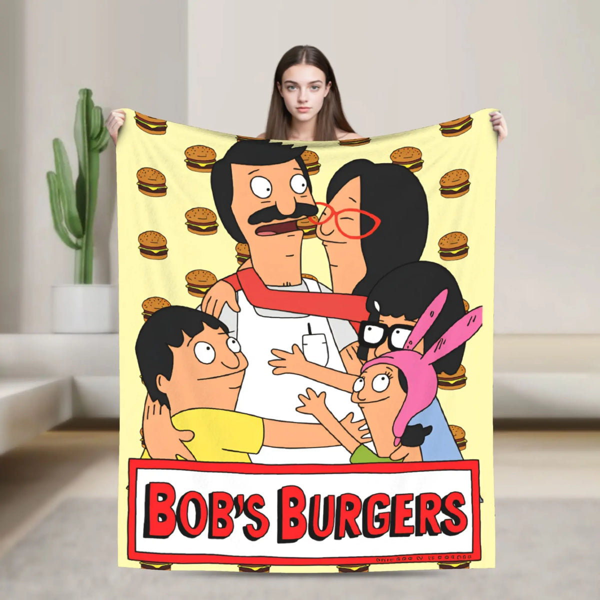 A throw blanket featuring characters from Bob's Burgers, including Tina Belcher and Linda Belcher.
