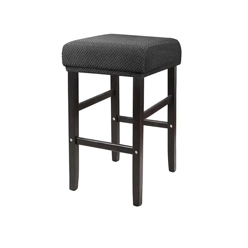 A dark brown woven fabric bar stool slipcover with a square seat and four wooden legs.