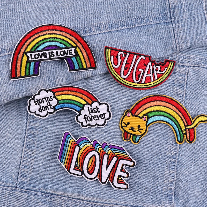 Rainbow letter patches featuring the words Love is Love and Sugar on a denim jacket