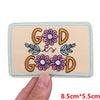 Light beige embroidered patch featuring the letters GOD surrounded by floral designs