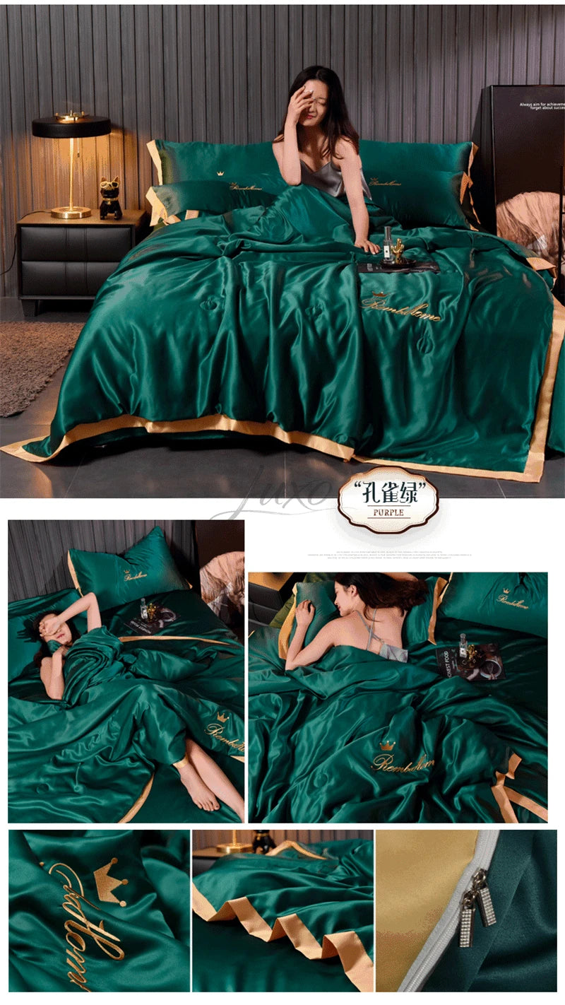 A luxurious emerald green ice silk blanket set featuring gold embroidery and a matching satin pillow in a bedroom setting.
