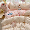 A pink polka dot duvet cover set with matching pillowcases and a stuffed animal pillow displayed in a bright, airy setting.