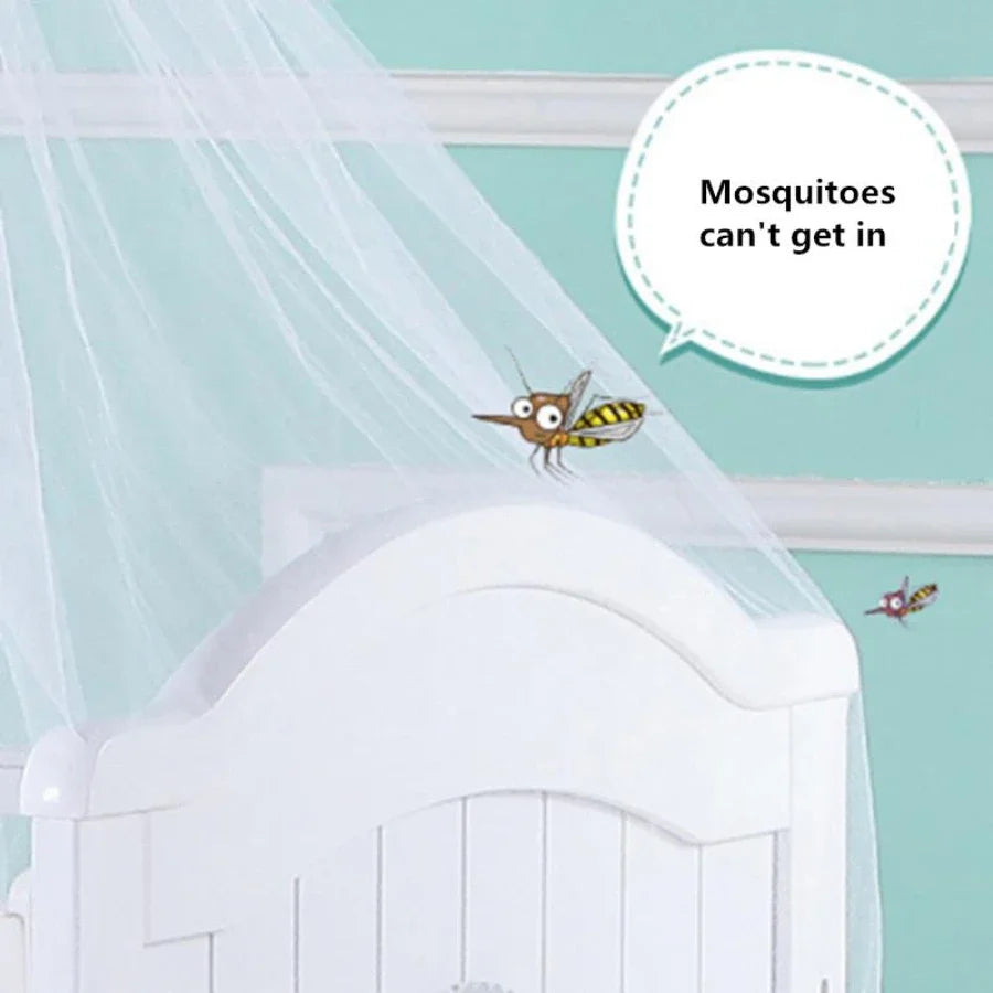 A mosquito net draped over a white crib railing with a small bee flying near it.