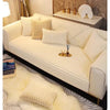 A cream colored plush anti-slip sofa seat cushion cover displayed on a modern sofa with light beige throw pillows.
