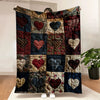 A patchwork flannel throw blanket featuring various heart prints in red, black, and gold tones.
