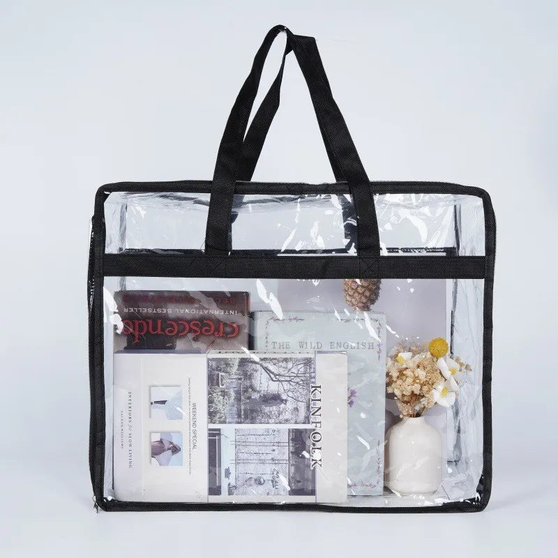 A clear plastic storage bag with black handles contains various stationery items and small decorative elements.