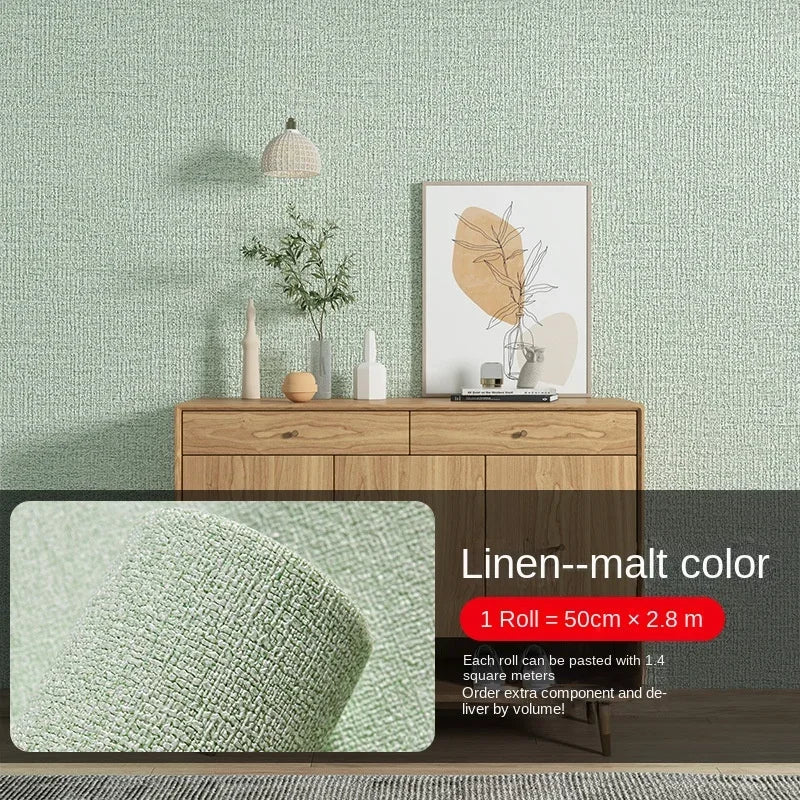 Self-adhesive 3D thermal insulation wallpaper in linen texture on a wall with wooden furniture and green fabric.