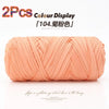 A skein of peach colored elastic yarn used for crafting.