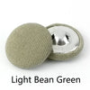 A set of light bean green round fabric-covered shank buttons for coats and jackets.