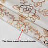 Close-up of a beige floral patterned fabric showing its soft, firm, and durable texture.