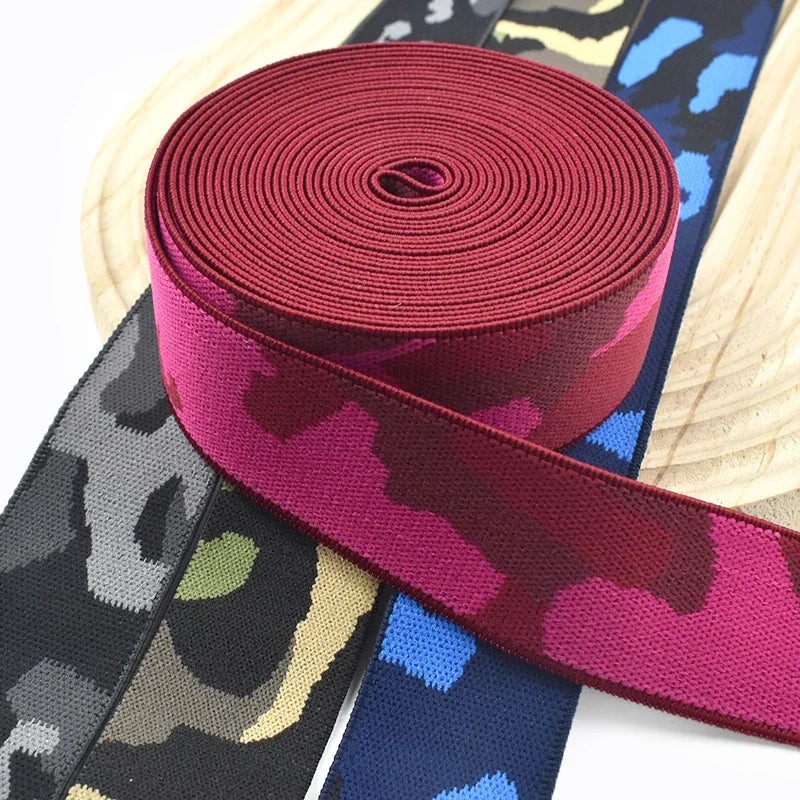 Roll of magenta camouflage elastic stretch ribbon for sewing and craft projects