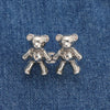 A pair of silver bear button pins designed for jeans.