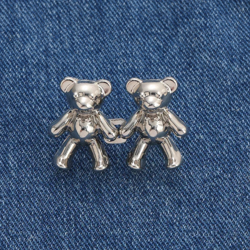 A pair of silver bear button pins designed for jeans.