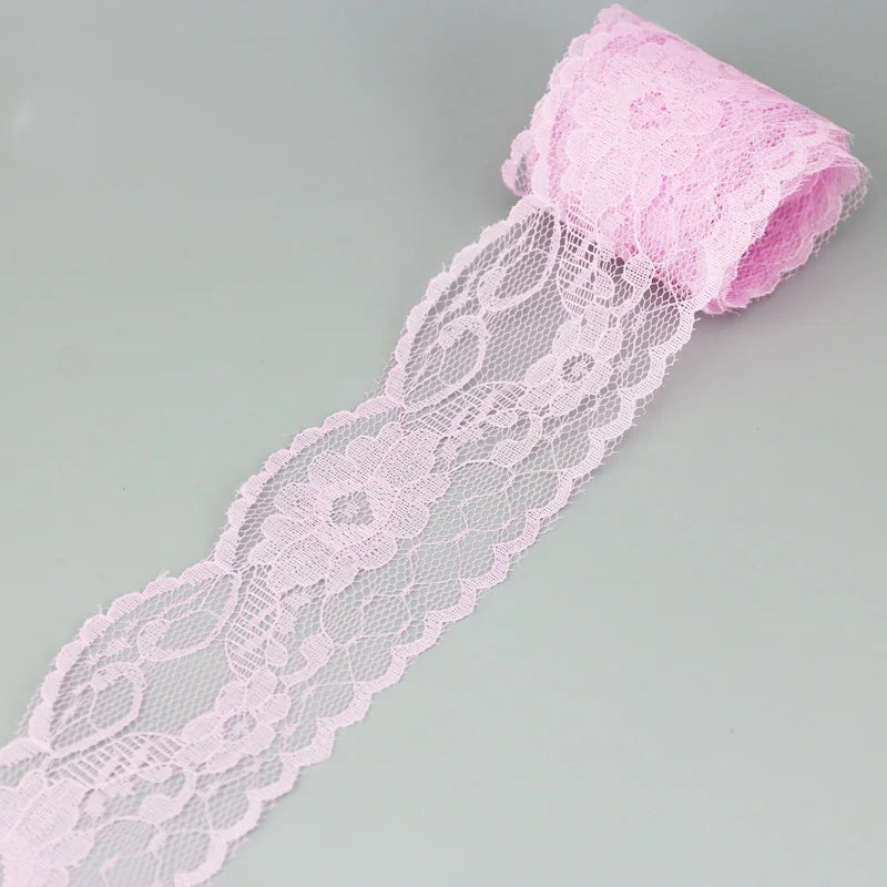 Pink decorative lace ribbon roll with a gathered top, shown flat.