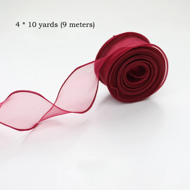 A roll of deep red silky organza ribbon, measuring 4 x 10 yards (9 meters), shown unwound.