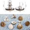 A collection of adjustable button pins and clothing pins made of metal on a denim background.