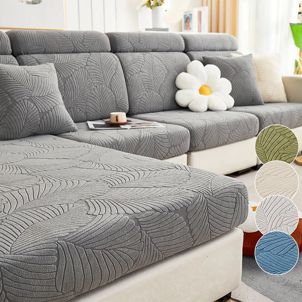 A gray luxury sofa slipcover featuring a textured leaf pattern with white decorative flowers.