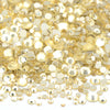 A pile of clear and gold glass rhinestones for DIY crafts