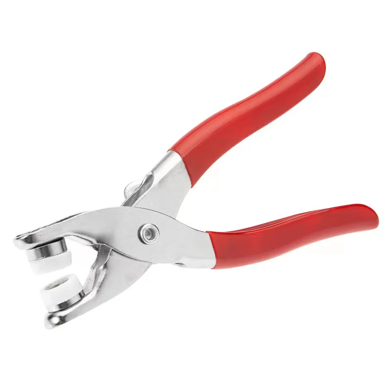 A pair of red and silver metal sewing scissors or button kit.