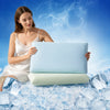 A woman holds a blue laptop resting on a light green cooling pillow, surrounded by ice cubes against a blue sky background.