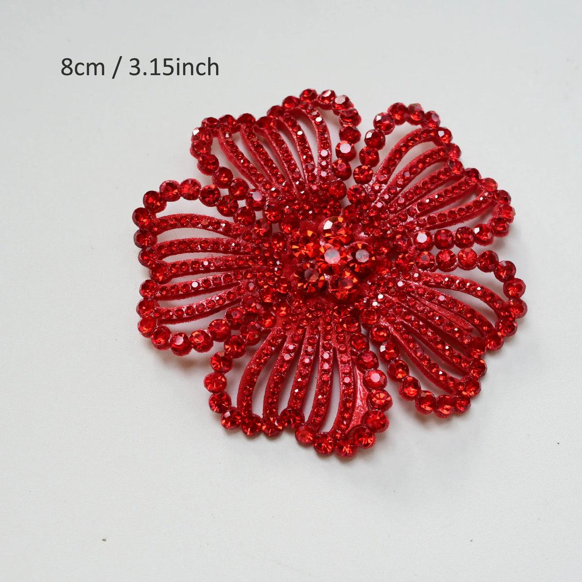 A vibrant red rhinestone flower applique patch measuring 8cm or 3.15 inches.