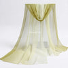 A sheer, light olive green fabric scarf draped in a flowing, pleated style for sensory play.