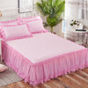 Pink princess lace bed skirt set with pink bedding and pillows in a bright room
