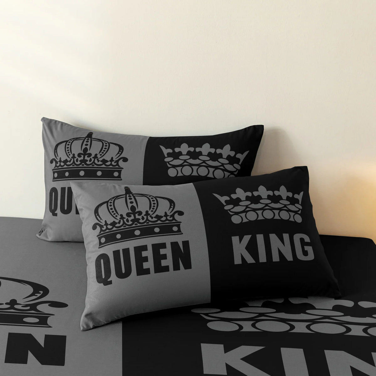 A set of three black and grey couple themed pillow covers featuring crowns and royal text.