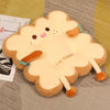 A plush cartoon toast shaped seat cushion with orange feet and a light yellow body.